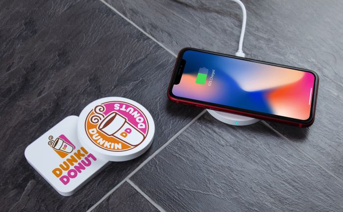 Round wireless charger branded with Dunkin Donuts